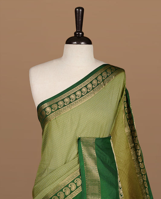 Pista colour semi georgette saree featuring gold zari check pattern on body, complemented by contrast green colour with zari border, paired with matching blouse piece.