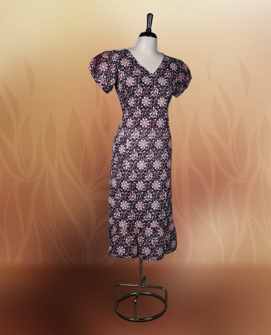 Black colour printed nightwear with soft floral patterns, V neckline, and puff sleeves, The flared hem adds a graceful touch, making it ideal for daily wear, casual outings, or comfy lounge days.