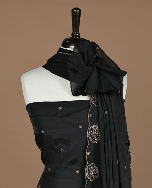 Black colour churidar material featuring floral cut beats and thread work on body, paired with matching bottom and dupatta.