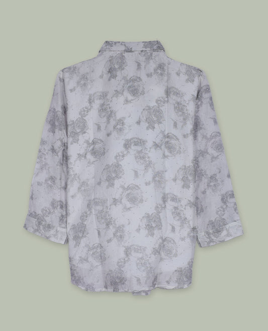 White longline floral printed shirt with collared neckline, full front button placket, long sleeves, and subtle all-over grey rose motifs.