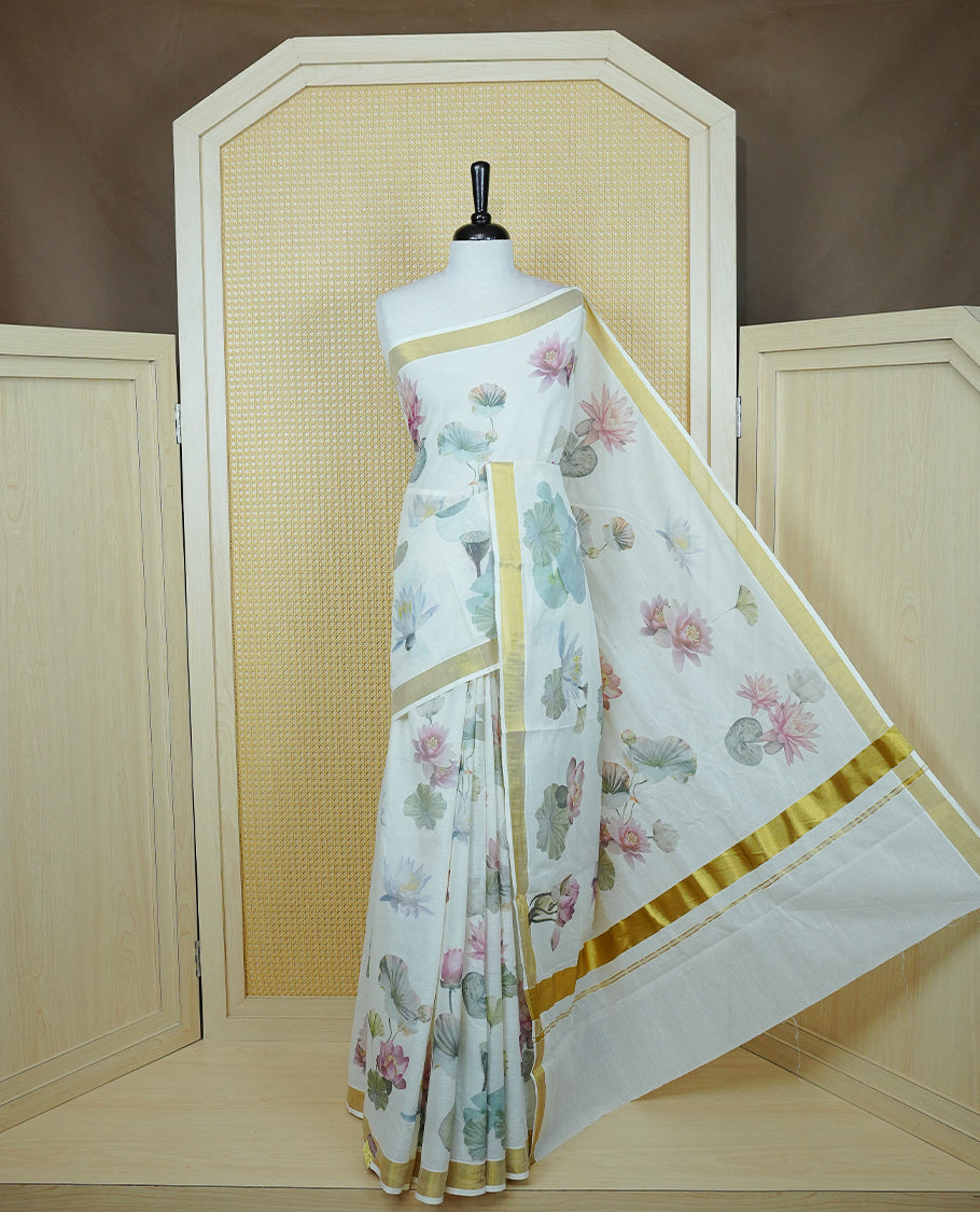 Cream colour Cotton kerala Saree featuring Lotus Print on body, Enhancing Gold zari kasavu border, comes with matching blouse piece.