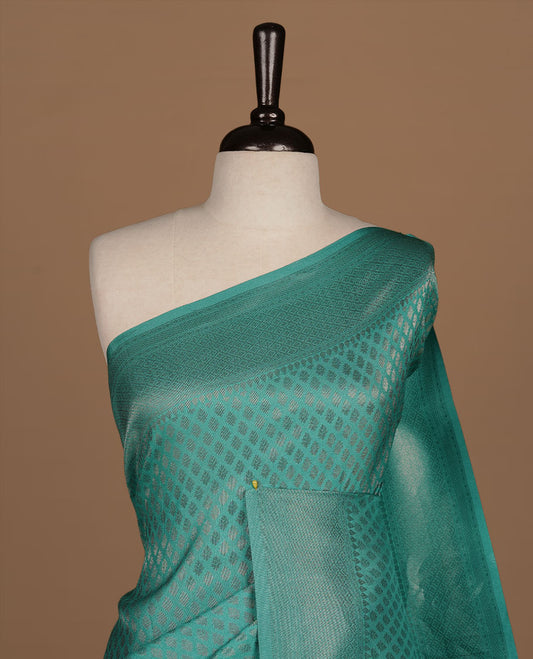 Aqua colour Semi Banaras Katan saree featuring Antique zari motifs on across body, complemented by self colour zari border, paired with matching blouse piece.