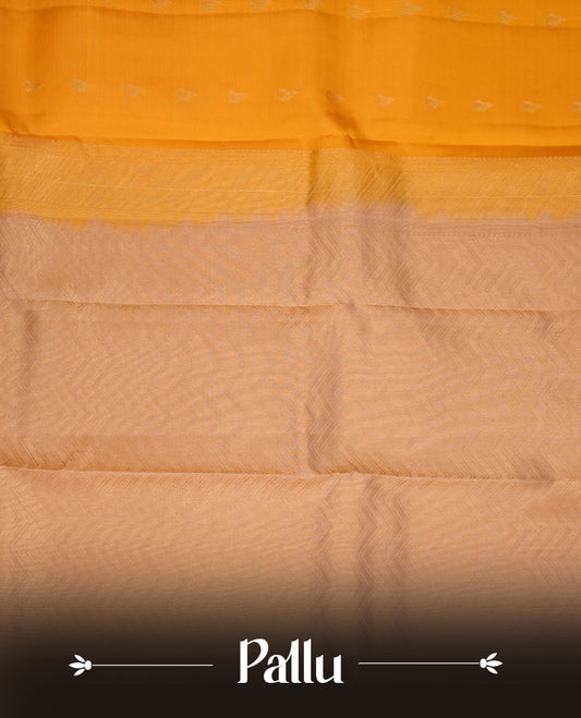 Mango yellow coloue vasundhara silk saree featuring zari buttas on body, complemented by contrast chikku with traditional border, paired with matching blouse piece