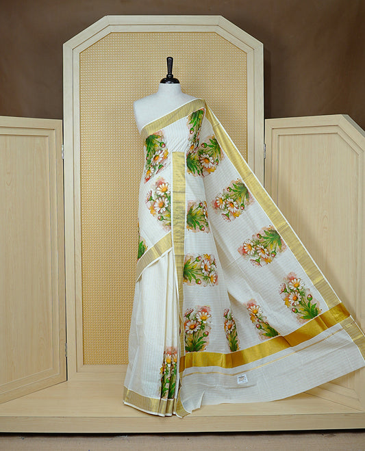 Cream Colour Kerala Saree Featuring Gold Zari Stripes On The Body, Enhanced By A Gold Zari Border With Floral Prints And A Matching Pallu, Paired With A Matching Blouse Piece.