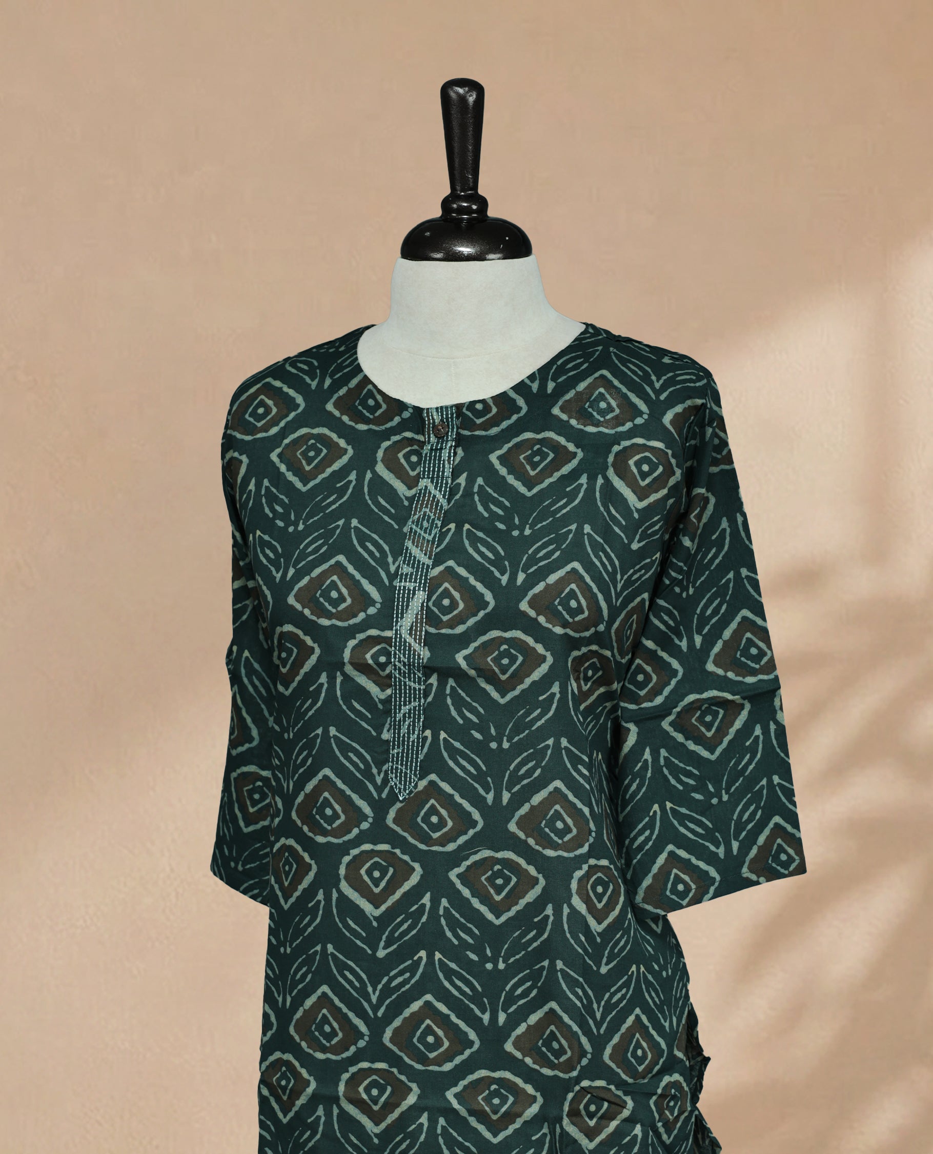Dark Teal Colour Kurti Faturing  geometric and leaf-inspired block print On Body , Round  Neckline  With Thread Detailing  & 3/4 Sleeve Design.