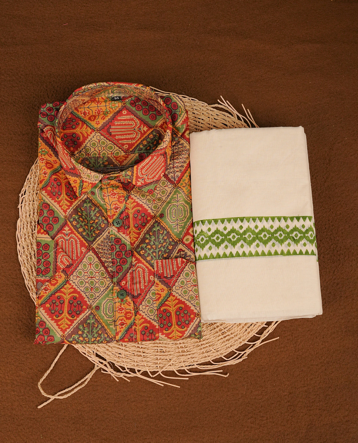 Brick red colour shirt featuring Floral Pattern printed body, paired with cream colour double dhoti featuring Green colour printed border.