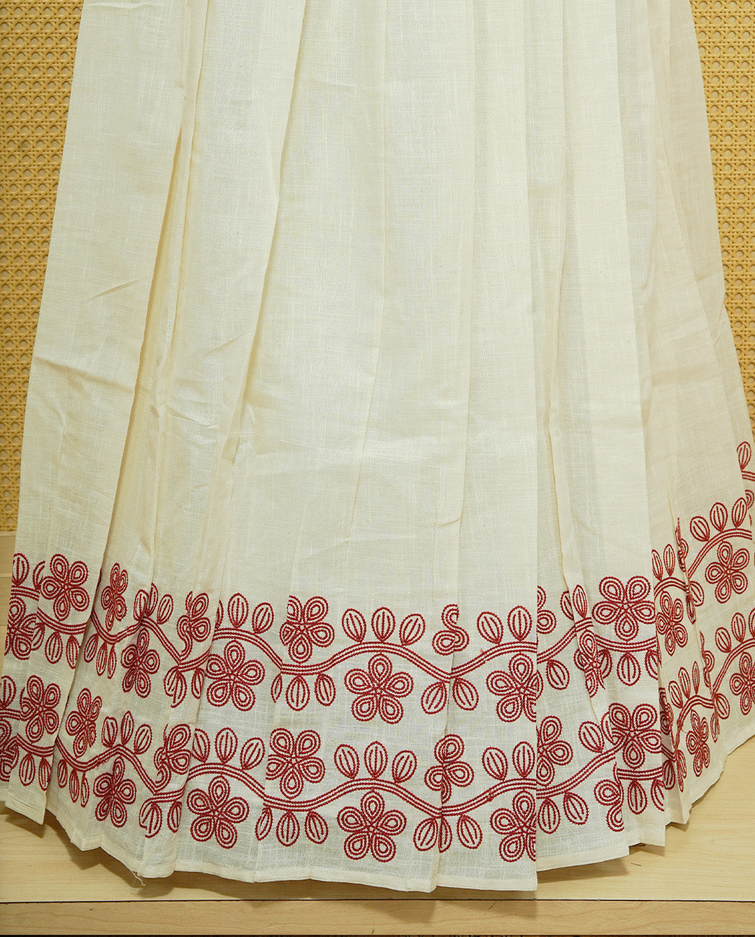 Cream colour cotton Stitched Skirt With Red colour Floral thread pattern on the border.
