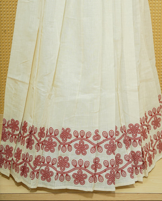 Cream colour cotton Stitched Skirt With Red colour Floral thread pattern on the border.