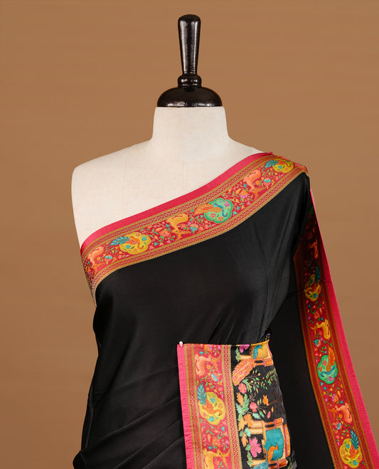 Black colour Pashmina Saree featuring elegant woven temple motifs, enhanced with a contrast pink woven border and a richly detailed traditional pallu, paired with a matching blouse piece.
