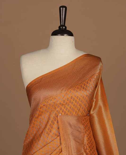 Orange colour semi banaras katan saree featuring Antique zari motifs on across body, complemented by self colour zari border, paired with matching blouse piece.
