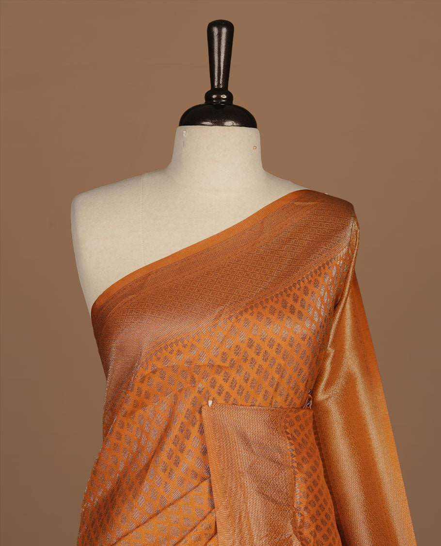 Orange colour semi banaras katan saree featuring Antique zari motifs on across body, complemented by self colour zari border, paired with matching blouse piece.
