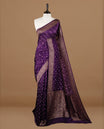 Purple colour Banarasi Bandhani silk saree featuring intricate antique zari circle Buttas across the body, complemented by an elegant antique zari border. Comes paired with a matching blouse piece