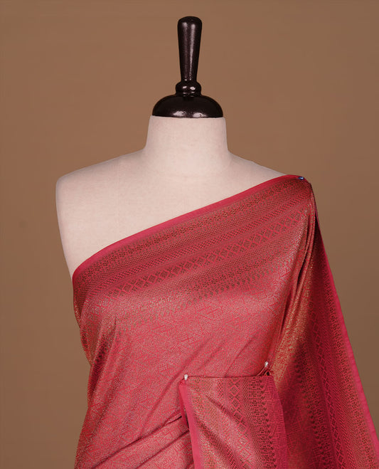 Rani pink colour semi banaras katan saree featuring Gold zari Pattern across body, complemented by self colour with zari border, paired with matching blouse piece.