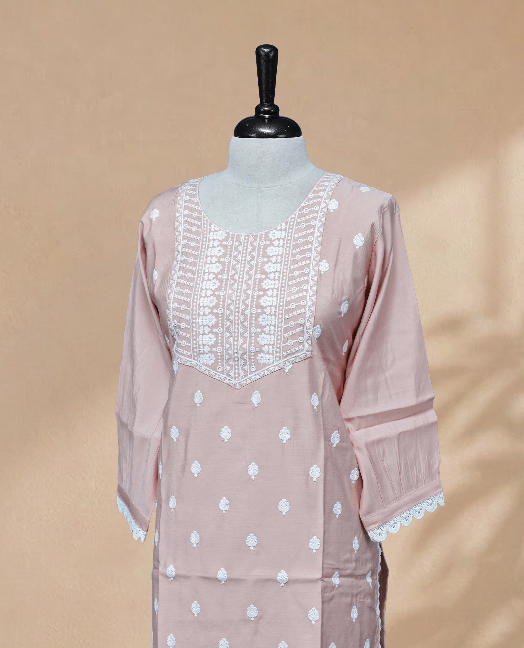 Peach Colour kurti featuring a classic U-shaped neckline, White Floral Embroidery Work on the body, and sleeves.