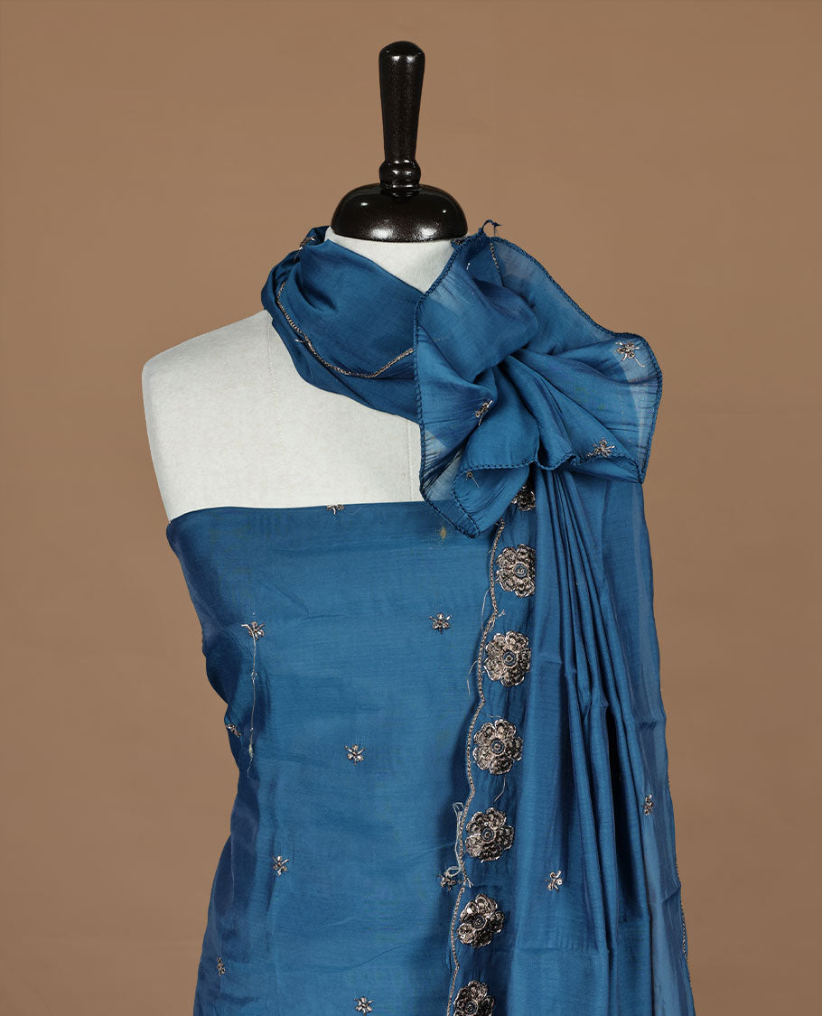 Blue colour churidar materal featuring floral cut beats and thread work on body, paired with matching bottom and dupatta.
