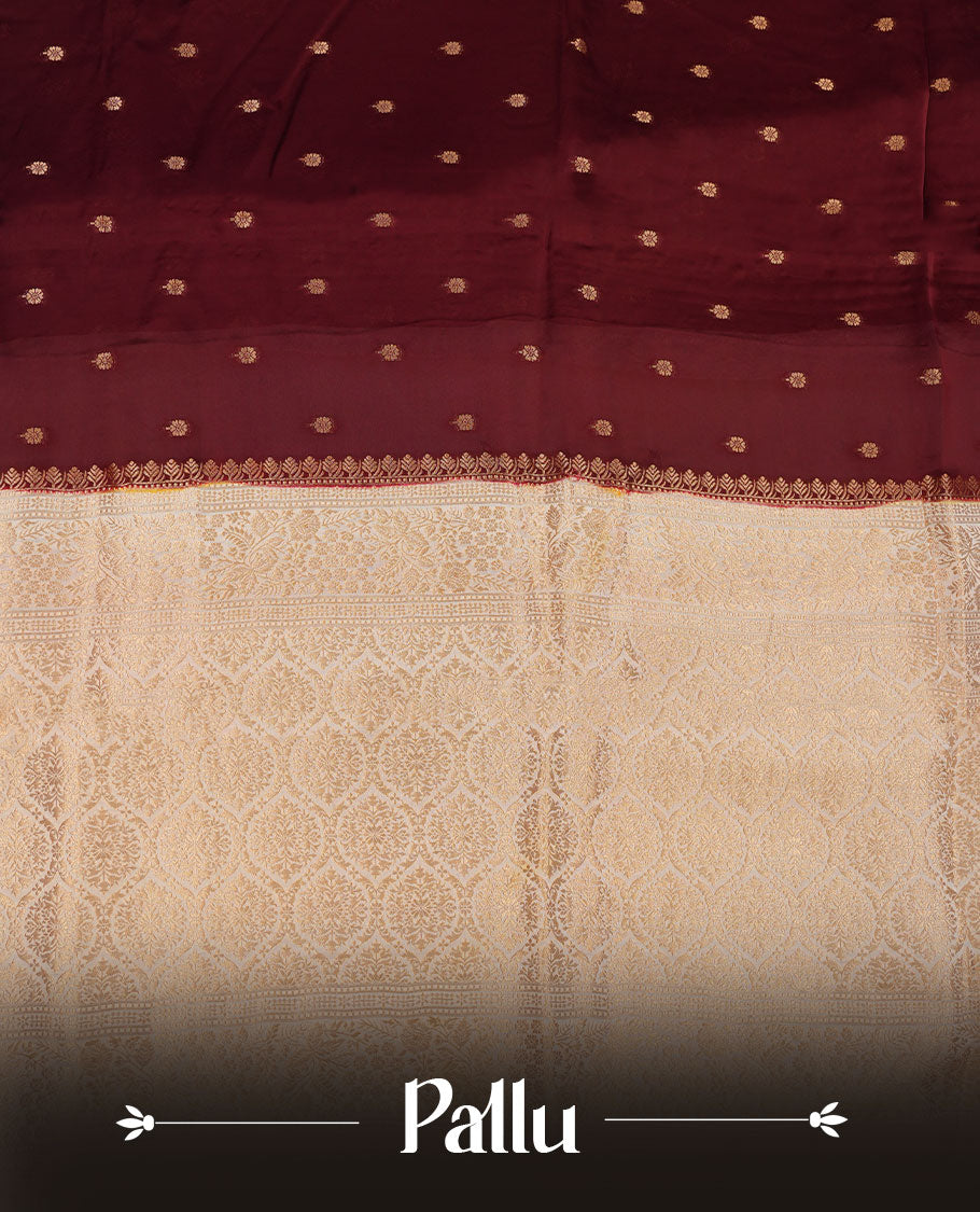 Chocolate brown colour banaras satin crepe saree featuring gold zari motifs on body, with contrast cream colour border with gold zari pattern and paired with matching blouse.