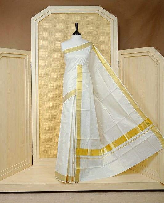 Cream Colour Cotton Kerala Saree Featuring A Golden Checks On Body, Enhanced With A Gold Zari  Border, A Traditional Gold Zari Pallu, And A Matching Blouse Piece.