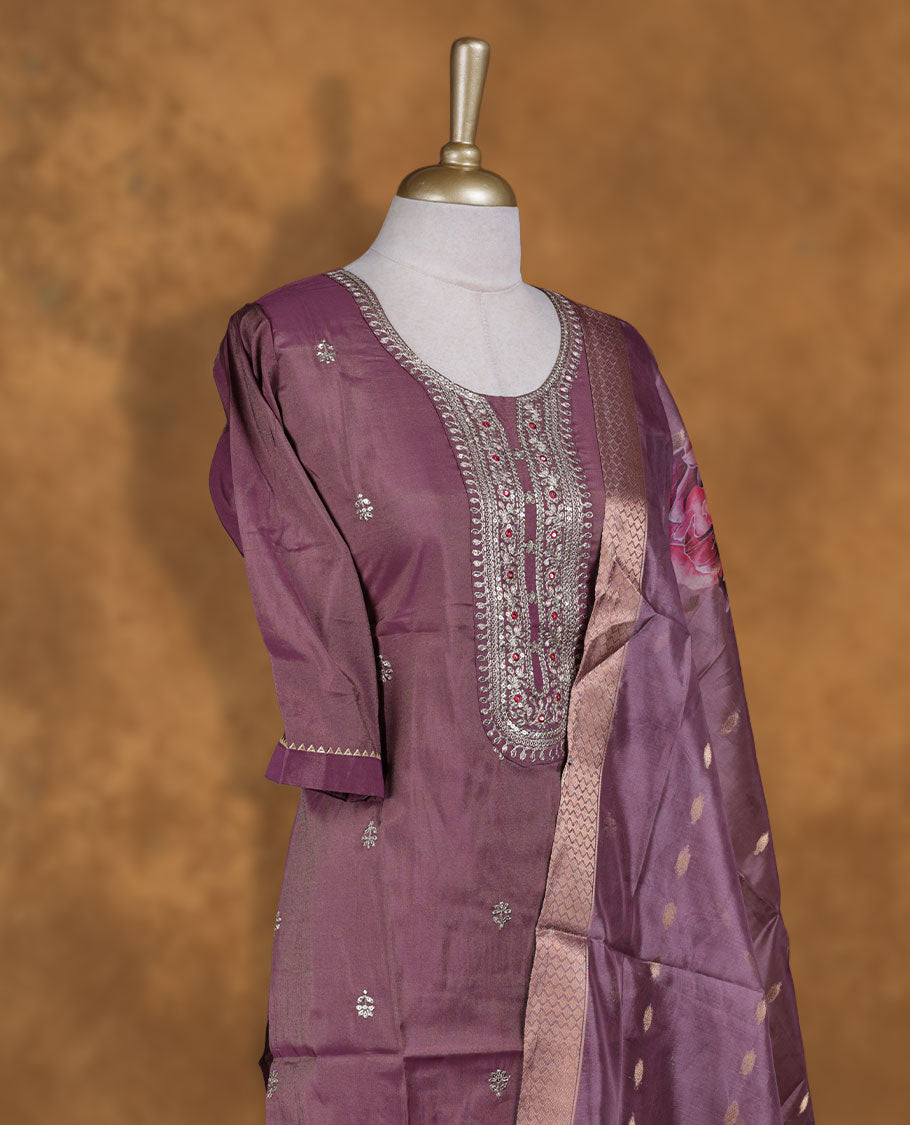 Dusty purple colour churidar set featuring Beats & thread embroidered neckline, sleeves, and Floral pattern body , Paired with a matching dupatta