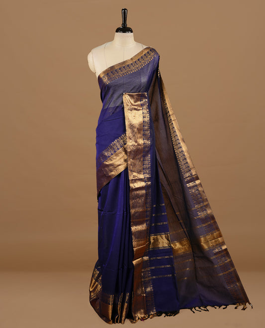 Navy blue colour chettinad cotton saree featuring elegant plain body, complemented by self colour with zari border, paired with matching blouse piece.