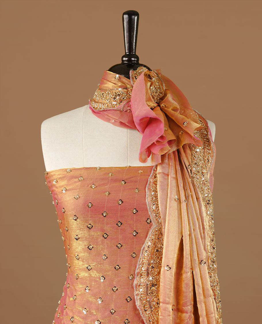 Peach colour churidhar material featuring cut beads and sequins work on the body, paired with a matching unstitched bottom and worked dupatta.