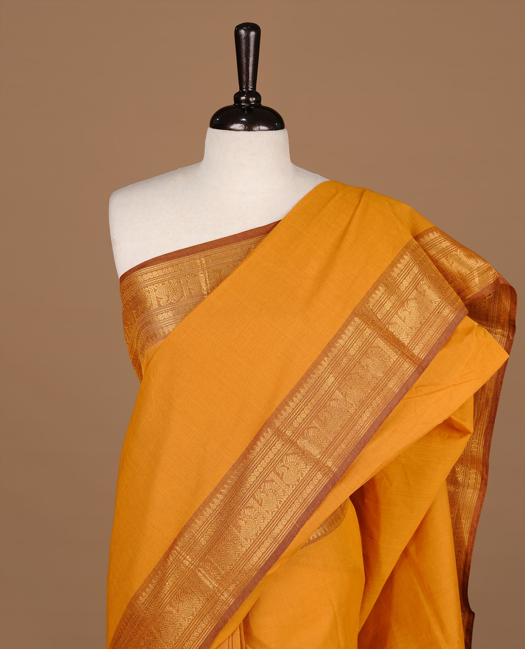 Mustard colour Chettinad cotton saree featuring Elegant plain body, complemented by contrast Light Brown colour with gold zari border, paired with matching blouse piece.