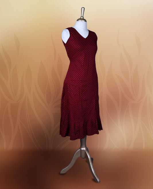 Dark maroon colour nightwear with orange colour polka dots, V neckline, and flutter sleeves & The flared hem with pleats adds a chic touch, Ideal for casual wear, office looks, or relaxed outings with a stylish twist.