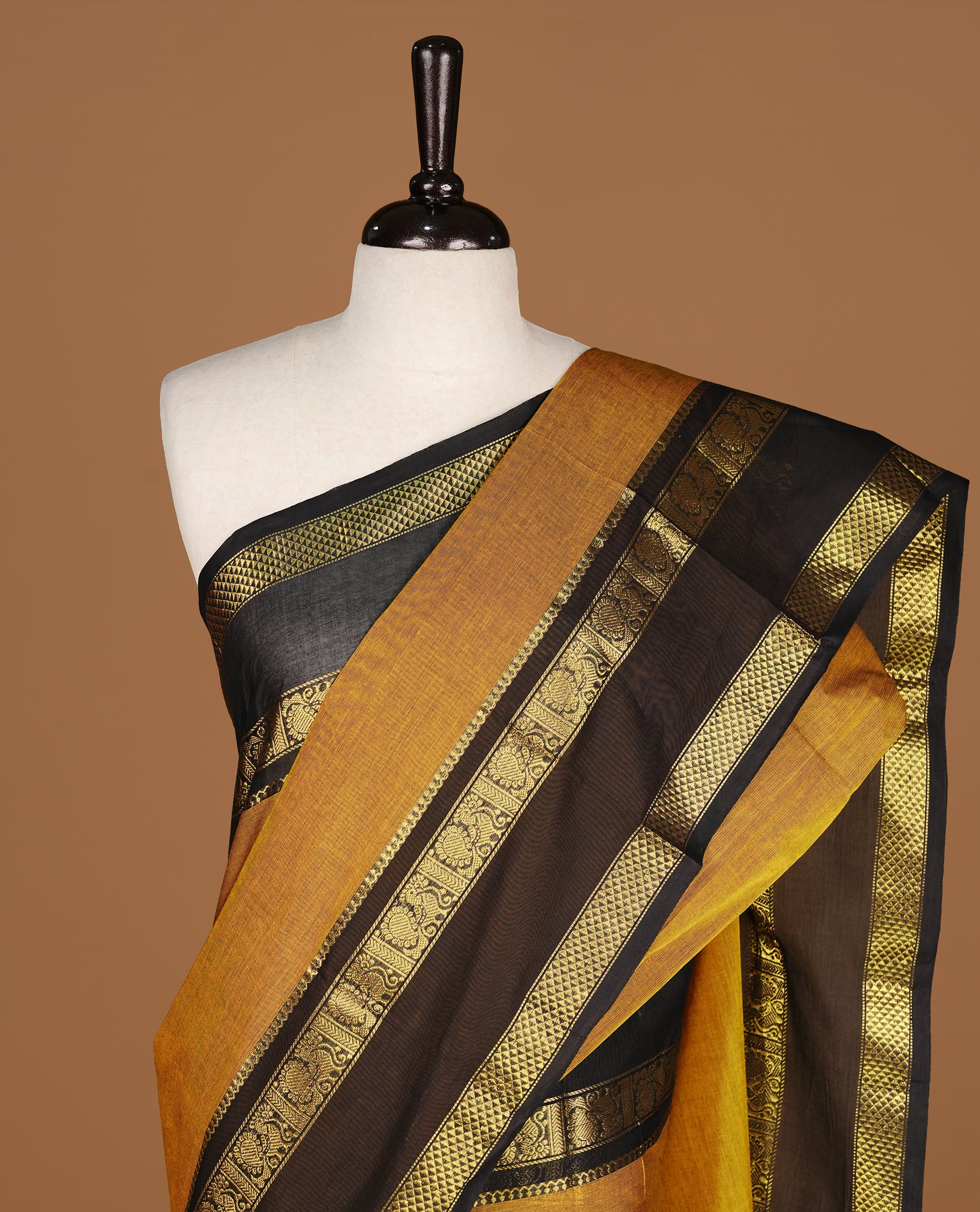 Mustard Colour Chettinad cotton saree featuring elegant plain body , complemented by contrast Black colour with traditional border, comes with matching blouse piece.
