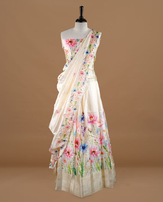 Off white colour semi stitched half saree featuring elegant pink colour floral prints, paired with a cream with traditonal zari border and matching printed dupatta ,paired with matching blouse piece.