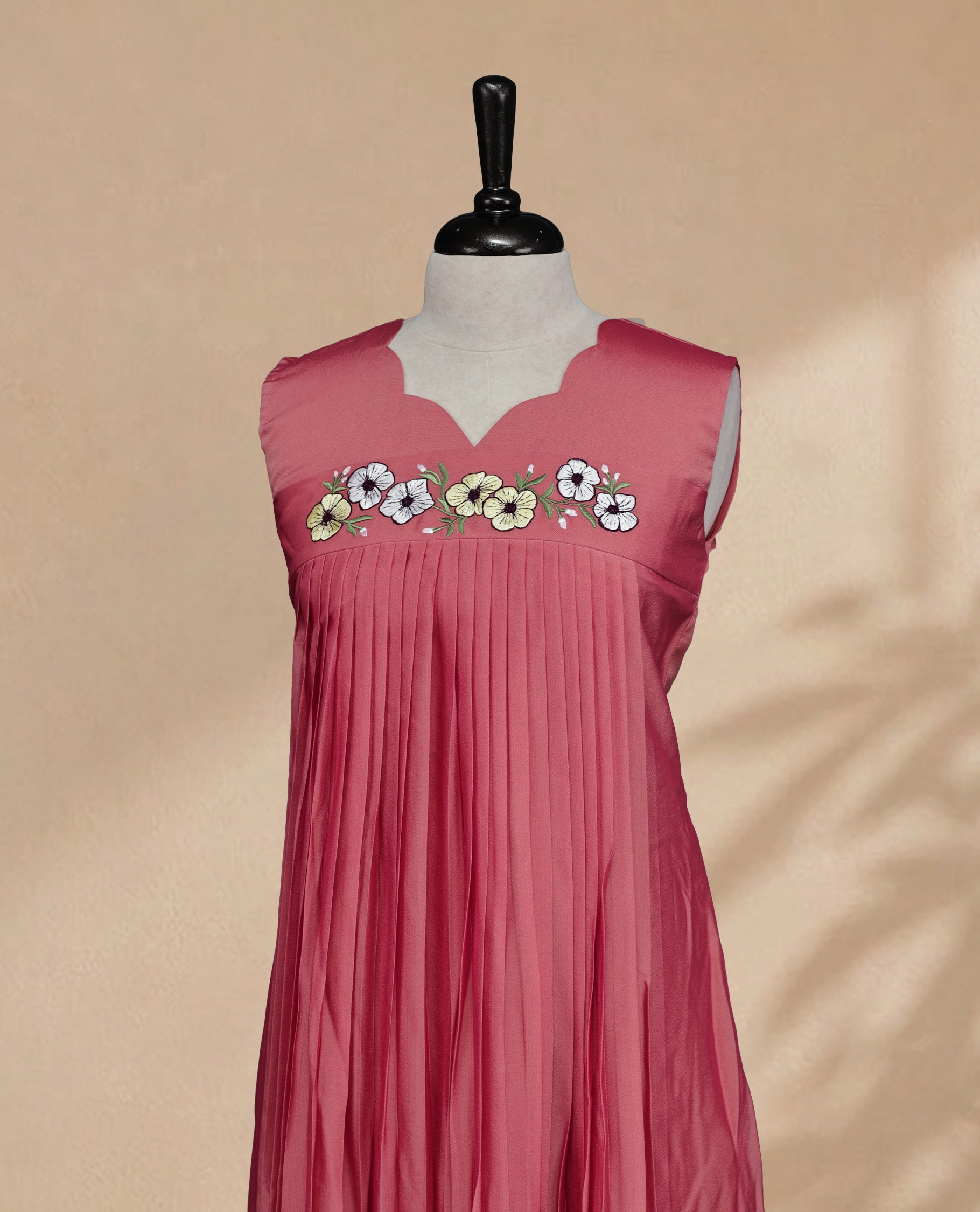 Peach Coloured Sleeveless Kurti Featuring a Designed Neckline, Floral Embroidery on the Body
