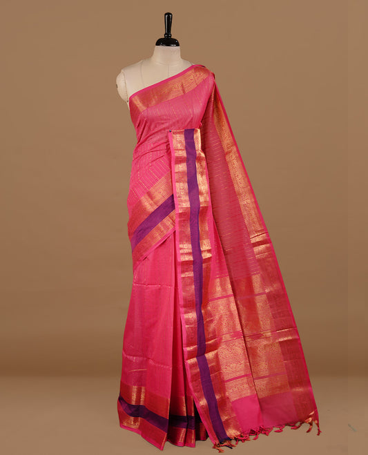 Magenta colour chettinad cotton saree featuring gold zari stripes on body, complemented by purple colour with zari border, paired with matching blouse piece.