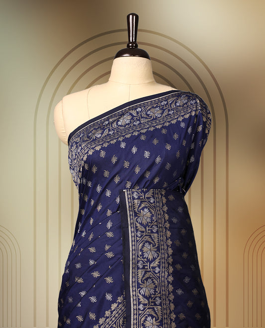 Graceful navy blue Banaras soft silk saree with gold zari buttas on the body, intricate floral zari border, grand pallu with paisley motifs, and a matching blouse. Perfect for weddings and celebrations.