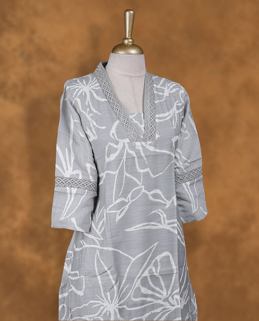 Ash colour kurti with gold & white colour printed pattern, knee length design, styled with a self colour lace Round neckline and a  sleeve .