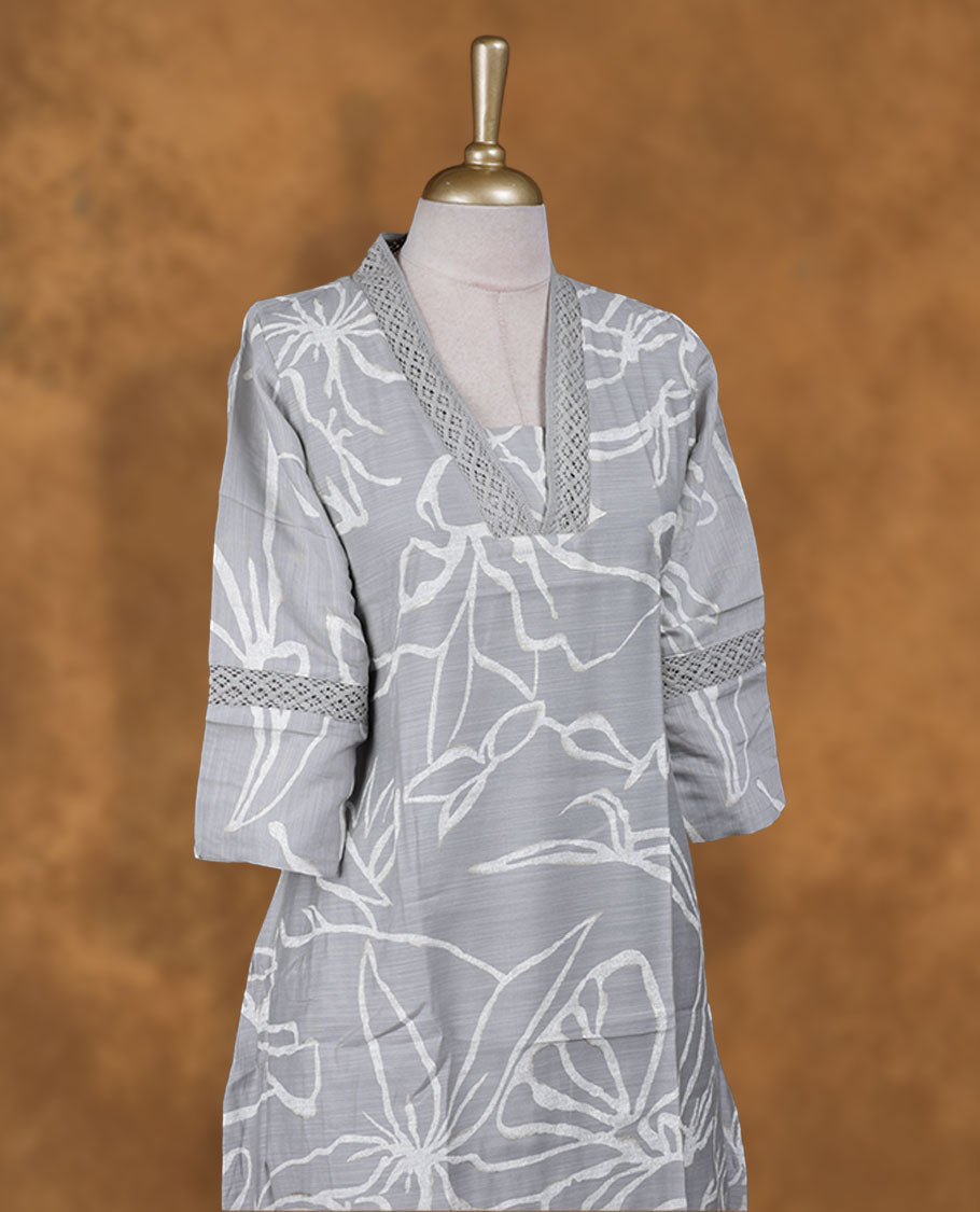 Ash colour kurti with gold & white colour printed pattern, knee length design, styled with a self colour lace Round neckline and a  sleeve .