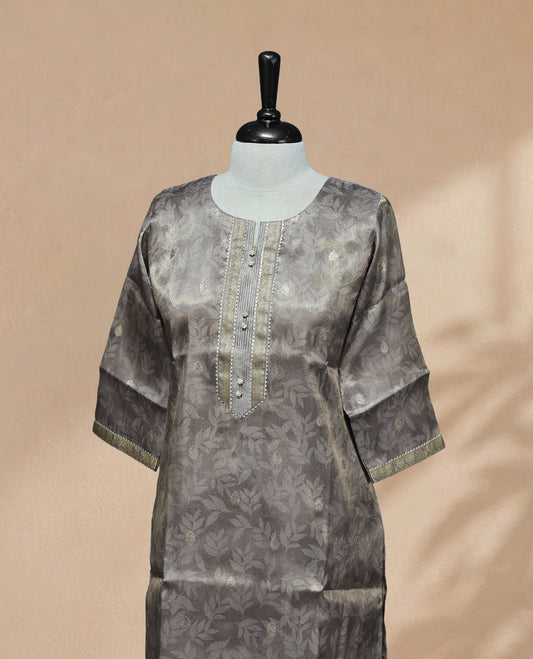 Grey colour Kurti featuring an intricate floral pattern, a round neckline adorned with detailed Stone & thread work, and 3/4 sleeves Design
