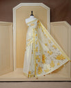 Cream Colour Tissue Kerala Saree Featuring Vibrant Floral Digital  Printed Border & Pallu , Beautifully Enhanced With A Classic Gold Zari Border And Contrast Tassels. Paired With A Matching Blouse Piece.