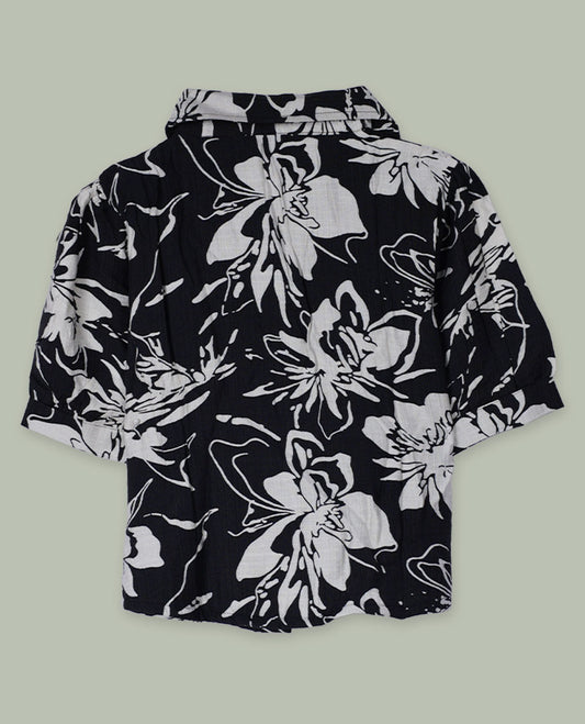 Black and white floral printed short-sleeve shirt top with collared neckline, front button placket, and softly gathered shoulders.