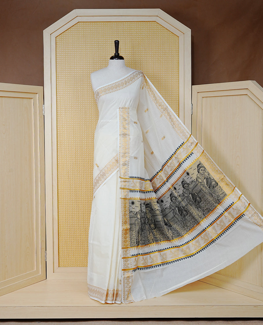 Cream Colour Cotton Kerala Saree Featuring Gold Buttas on the Body, a Classy Gold Zari Border, and a Traditional Black Colour Lord Krishna Thread work and Gold Zari Pallu, Paired with a Matching Blouse Piece.
