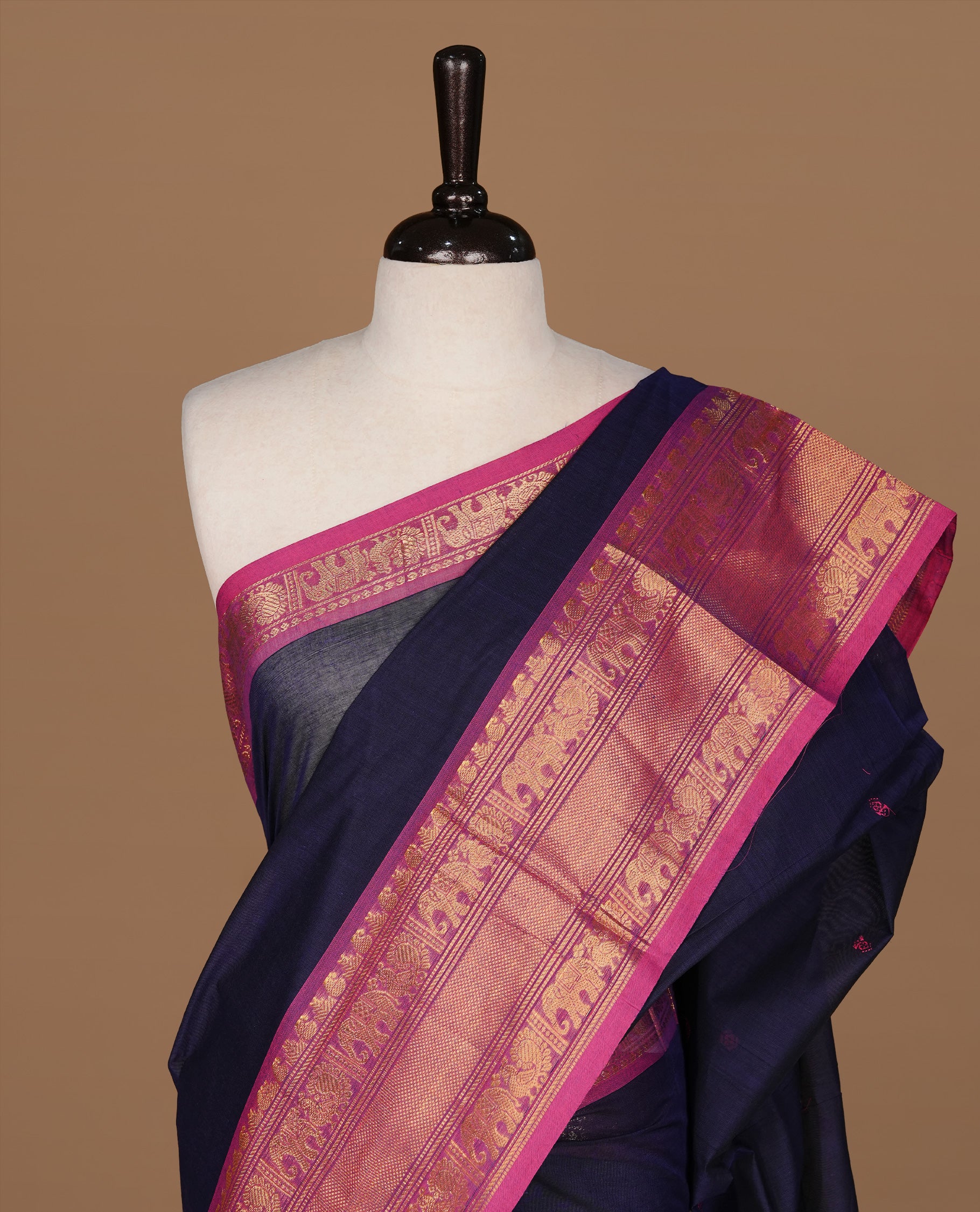 Navy Blue colour Chettinad cotton saree featuring motifs on body , complemented by contrast Magenta colour with zari border, comes with matching blouse piece.