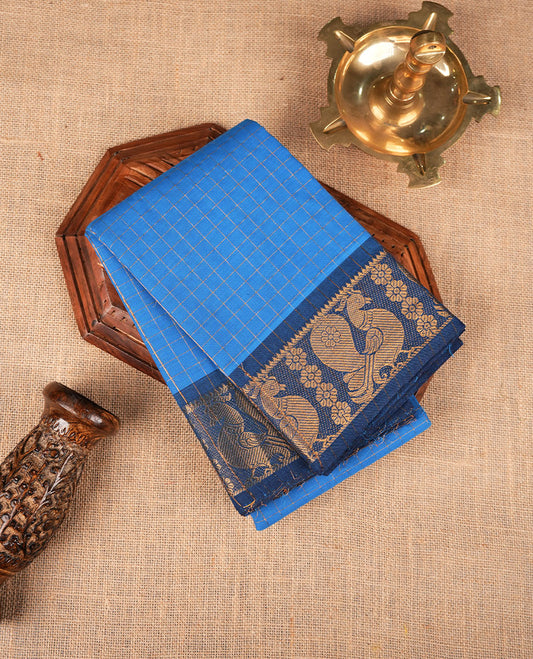 Blue colour sungudi cotton saree featuring gold zari check pattern across body, contrast Dark blue colour with gold zari peacock and floral pattern on border, without blouse piece.