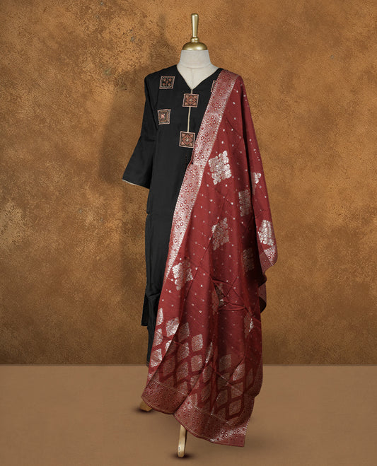 Black colour churidar set featuring thread embroidered pattern neckline, sleeves, and body , Paired with a contrast brick red colour dupatta