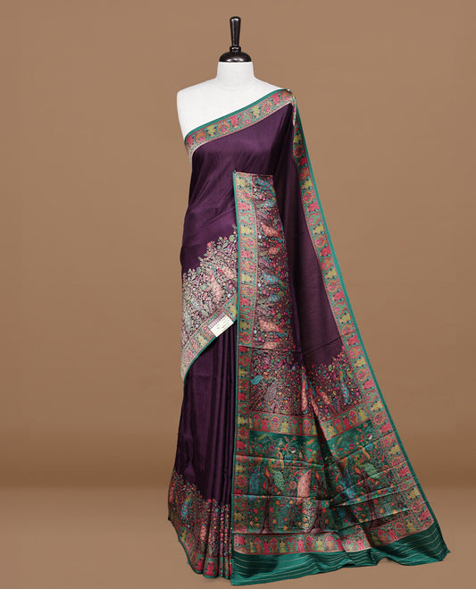 Deep Purple Pashmina silk saree featuring floral Pattern body, complemented by red border with multi colour Peacock & floral motifs, complete with matching blouse piece.