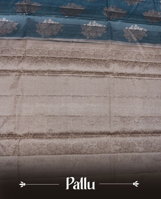 Teal colour pure banaras tusser silk saree highlighting antique zari pattern across body, with contrast cream colour with zari border and paired with matching blouse