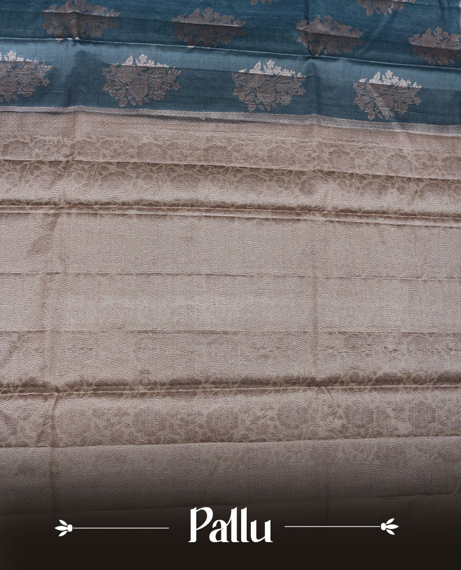 Teal colour pure banaras tusser silk saree highlighting antique zari pattern across body, with contrast cream colour with zari border and paired with matching blouse