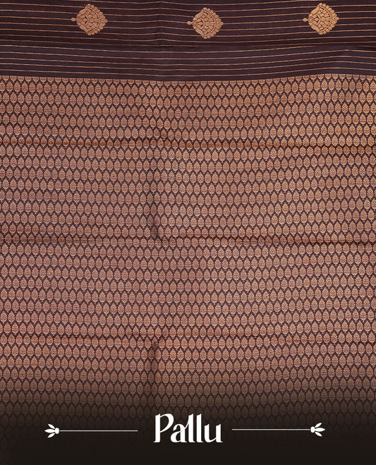 Dark chocolate colour soft silk saree featuring Gold zari stripes & motifs on body, complemented by self colour with traditional border, paired with matching blouse piece.
