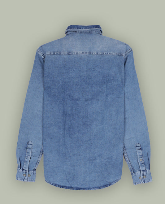 Light blue colour denim shirt with a faded wash finish, Features two front flap pockets, button down closure, and long sleeves with cuffs, Perfect for a rugged yet casual look.