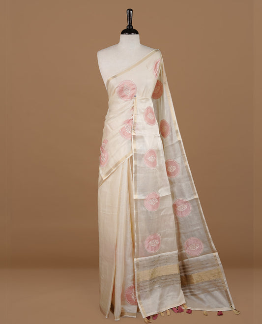 Cream colour Tussar saree featuring pink colour circle pattern with chikankari embroidery work, highlighting gold zari simple border, paired with matching unstitched blouse.