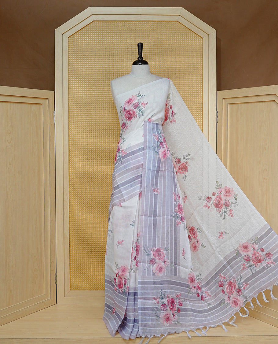Cream colour semi linen saree featuring Red colour floral print on body, complemented by contrast Strip pattern border, comes with matching blouse piece.