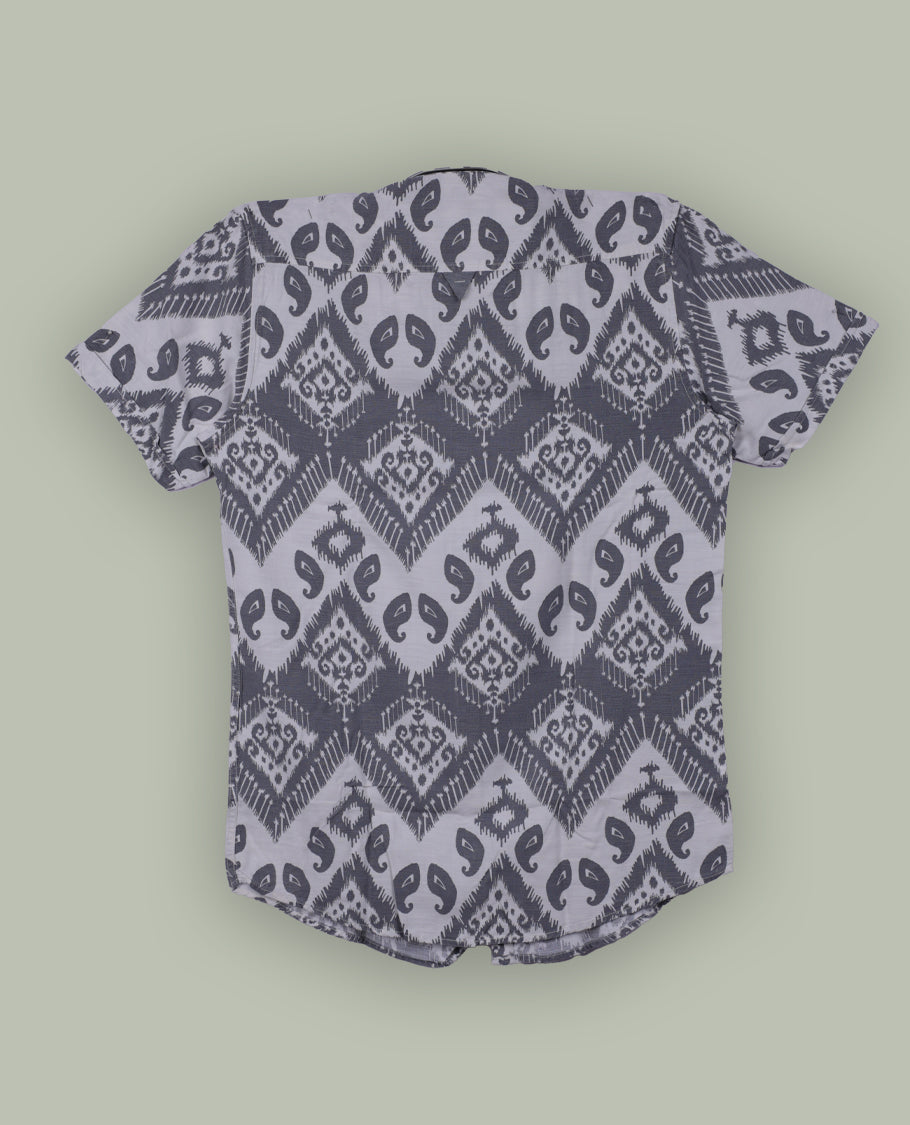 Off white colour shirt featuring stylish grey prints all over, Designed with a classic shirt collar and short sleeves, this shirt offers a modern yet casual appeal.