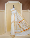 Cream Colour Cotton Kerala Saree Featuring an Elegant Plain Body, a Classy Gold Zari Border, and a Traditional Gold Zari Pallu with Maroon Accents, Paired with a Matching Blouse Piece.