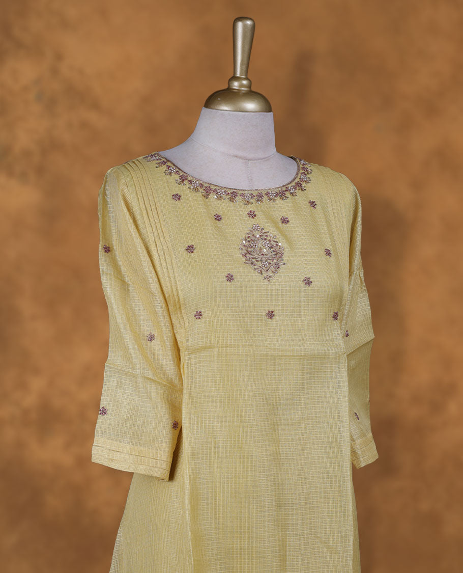 Yellow colour kurti with gold colour thread & beats floral thread pattern, knee length design, styled with a Round neckline and a  sleeve .